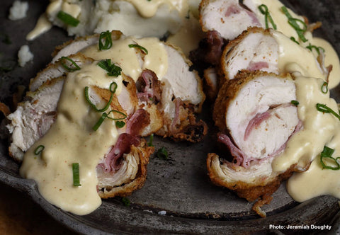 Image of cut turkey cordon bleu with sauce drizzled on top.