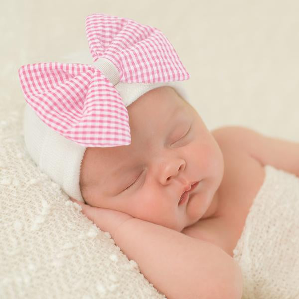 white baby hat with bow