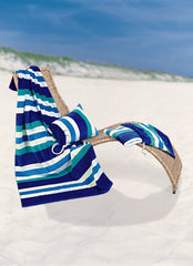 Blue stripe towel and pillow bag placed on a deckchair on a beach