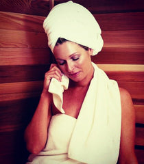 woman in spa wearing a towel around her head and covering her midsection
