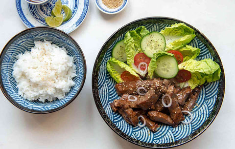 Blue bowls with jasmine rice and beef in
