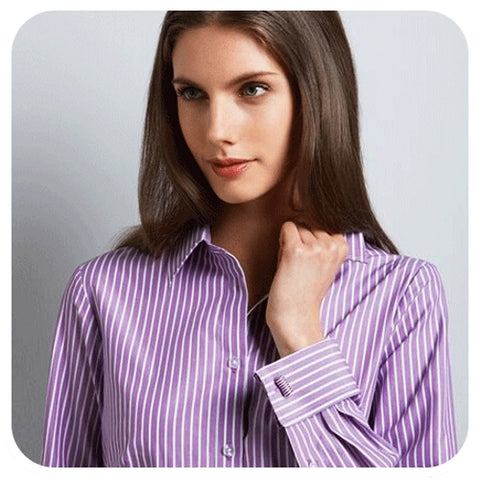 Woman wearing cufflinks on purple and white striped double French cuff shirt