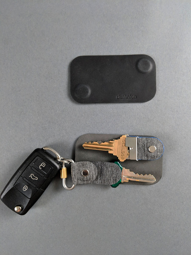 uncovered keyfoilio cover with three keys inside and a fobring attachment