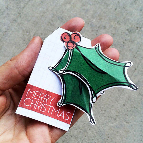 christmas holly gift tag in hand