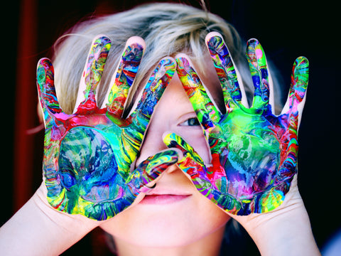 Kid's hands covered in paint