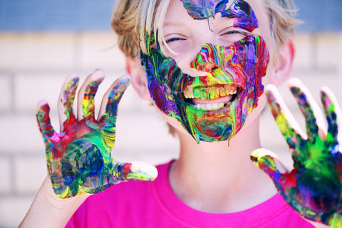 boy covered in paint as outdoor game
