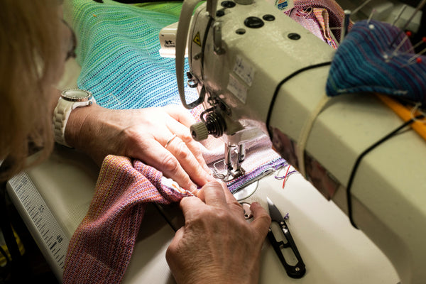 A women sewing a Signature product.