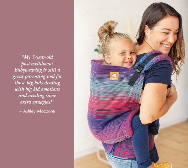 A smiling mother daughter duo using a Preschool Carrier in back-carry position.