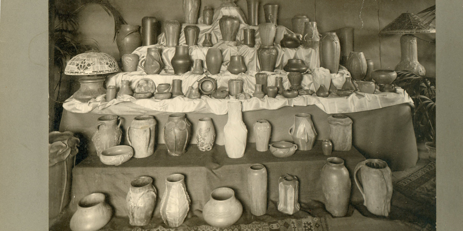 Sepia photo scan of a variety of early Pewabic vases at the Stable Studio in the early 1900s.