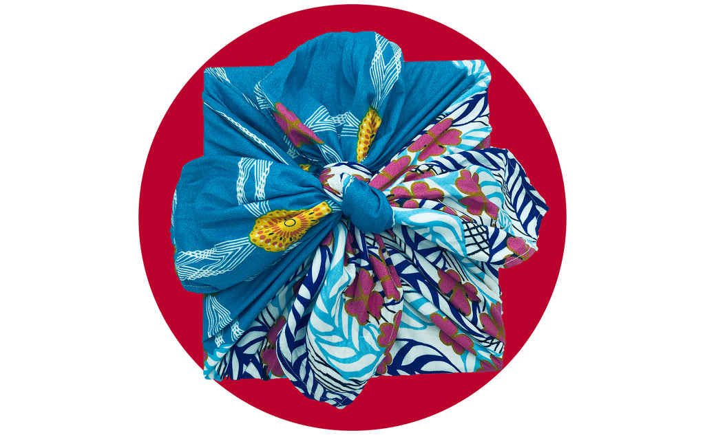 Furoshiki wrapped gift on Japanese flag red background
