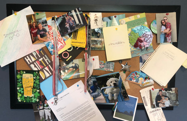 College student's bulletin board filled with notes and memorabilia