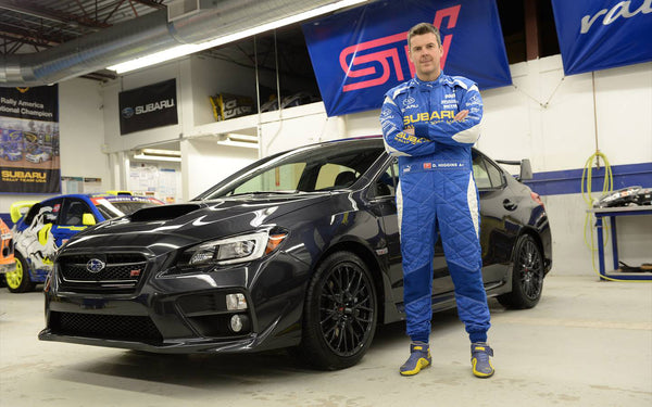 David Higgins stands next to the all new 2015 Subaru STI which he will pilot later in the 2014 Rally America season. 