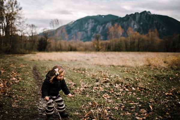 girl playing in the woods