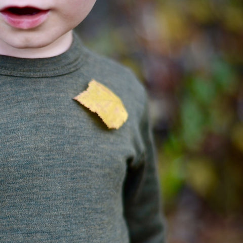 detail of a yellow leaf on a green base layer top