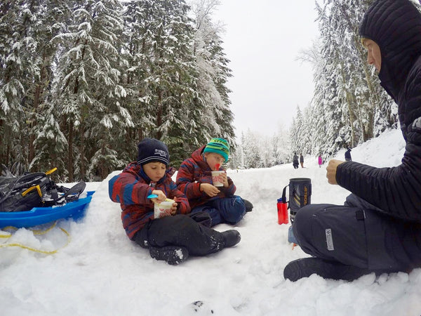 kids eating in the snow