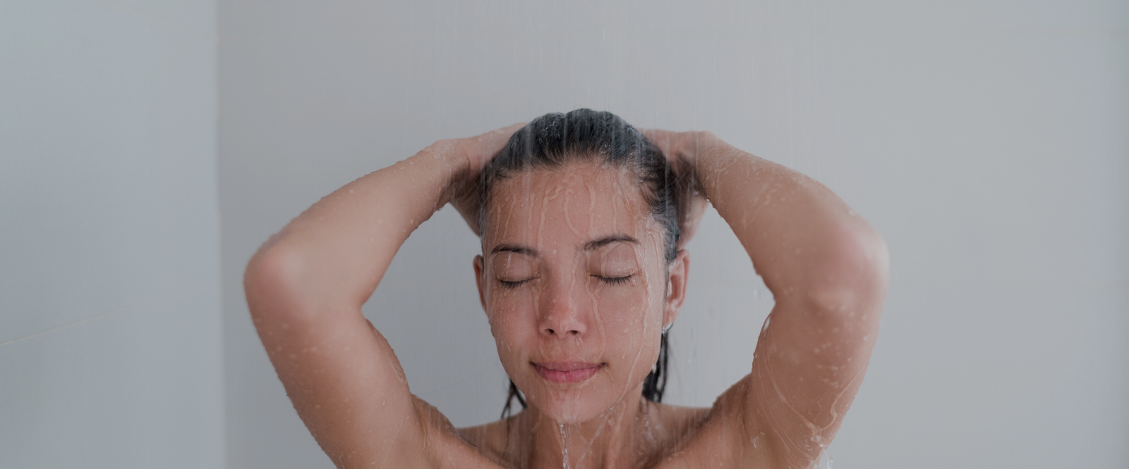 woman in shower inhaling essential oils