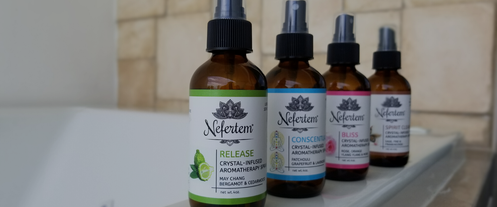 nefertem aromatherapy sprays on ledge of bathtub