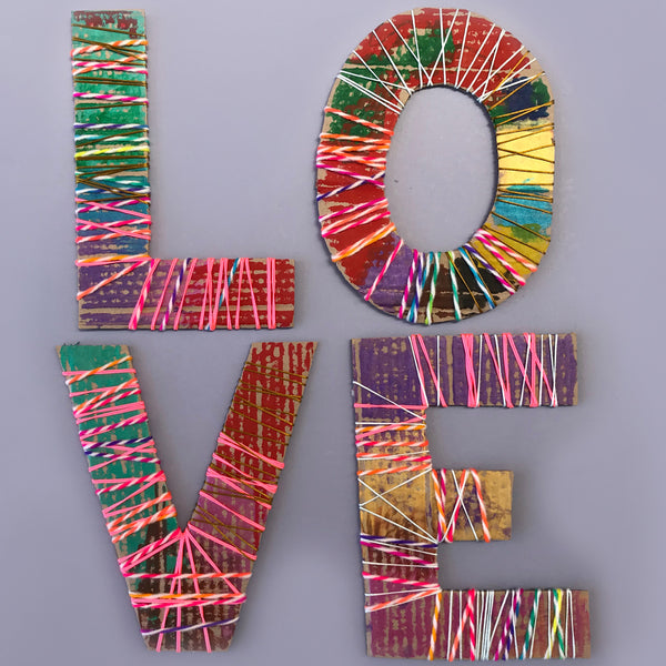 Large cardboard letters wrapped in yarn, wool and cord