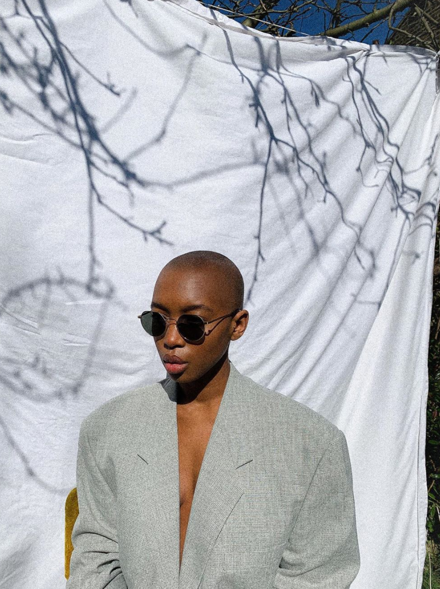 Marisa Martins, fashion stylist and Instagram influencer, wearing a tonal suit and round sunglasses