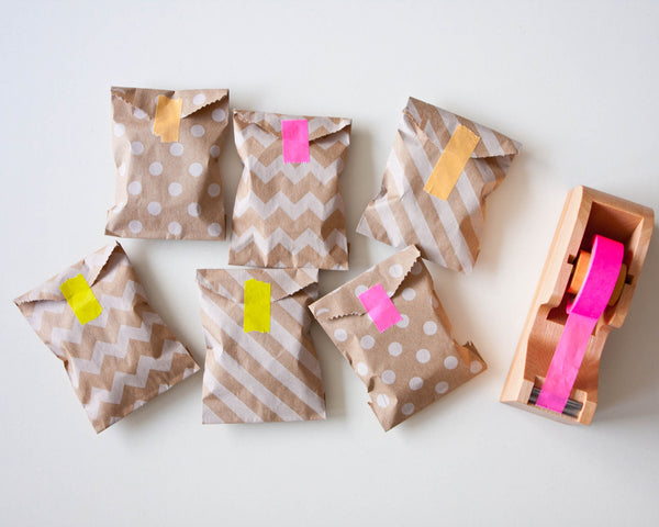 Mini paper bags with colorful tape closing them