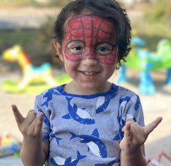 boy with spider man face paint