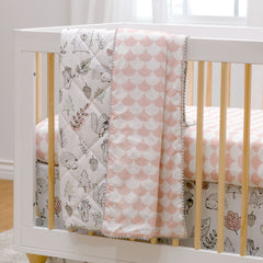 Lolli Living Quilted baby blankets draped over a crib