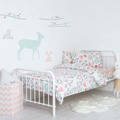 Lolli Living blankets covering a baby bed in a white nursery with animal prints on wall