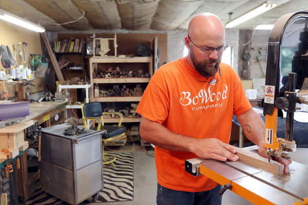 TJ Bowen cuts a piece of walnut to make a spurtle, one of BoWood’s signature kitchen utensils, in BoWood's shop in Vinton.