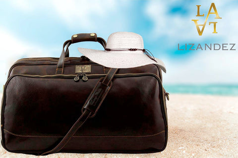 Leather Travel Bag Sitting On A Lovely Beach With A Sun Protection Hat