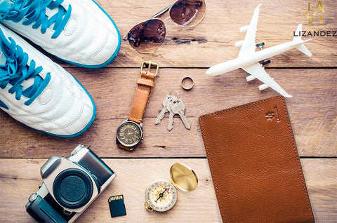 Leather Passport Wallet being Displayed On A table With Model Aeroplane. Watch, Sneakers Camera And Accessories