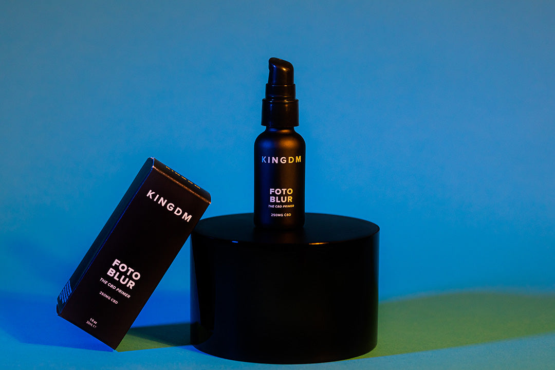 Kush Queen's Kingdm Cosmetics CBD Primer shown with its box against a blue background. 
