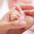 adult hand holding baby's hand – BEB Organic skincare products – Luxury, health-filled skincare for preemies – premature baby - BEB Organic Bubbly Wash - BEB Organic Silky Cream - BEB Organic Healing Gel - BEB Organic Nourishing Oil - BEB Organic Diaper Balm – Kim Walls, Preemie Skincare Expert 