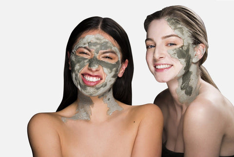 two women with clay masks