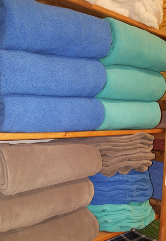 fleece blankets on the shelves at massage therapy supply outlet