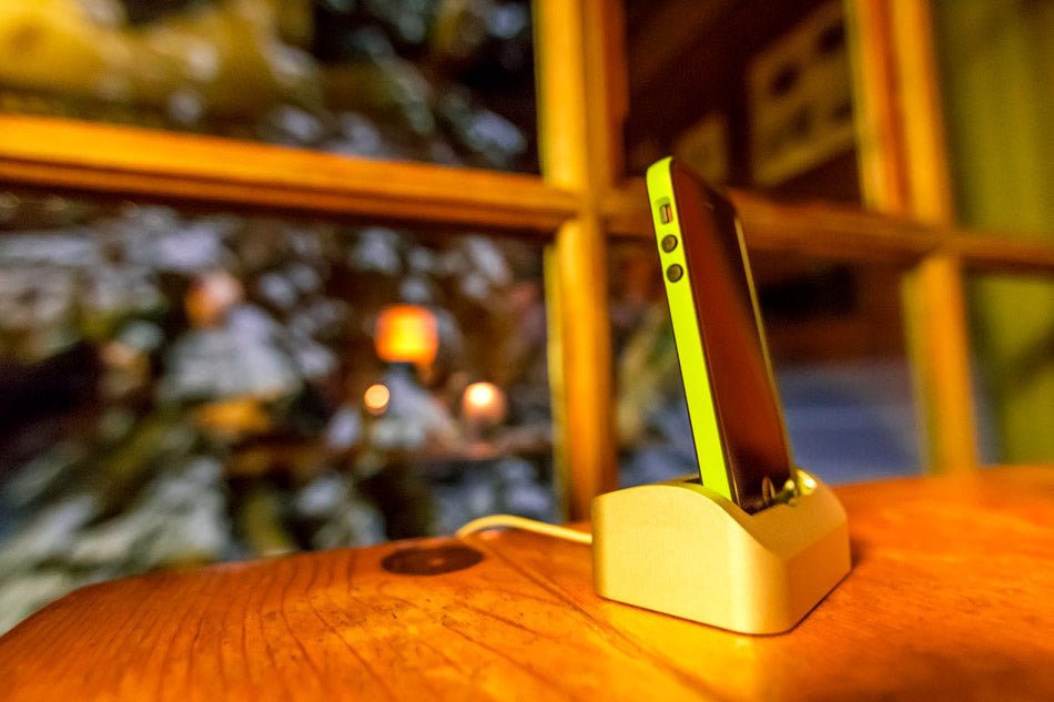 Elevation Dock with neon case on wood table