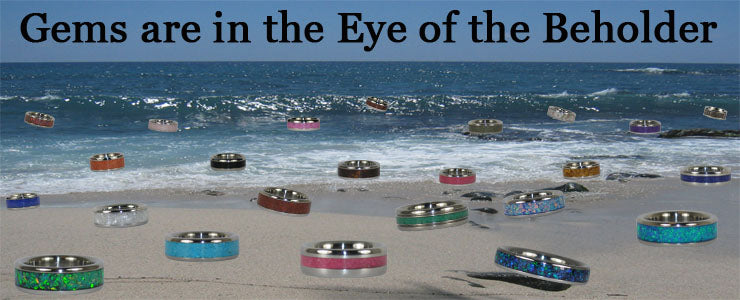 Gems are in the eye of the beholder - gemstone inlay titanium rings sitting on the beach in Hawaii