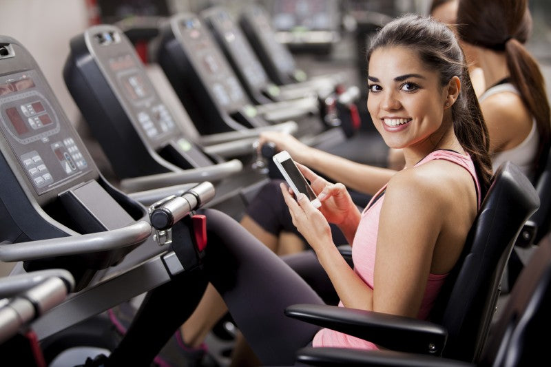 Woman Texting at the Gym