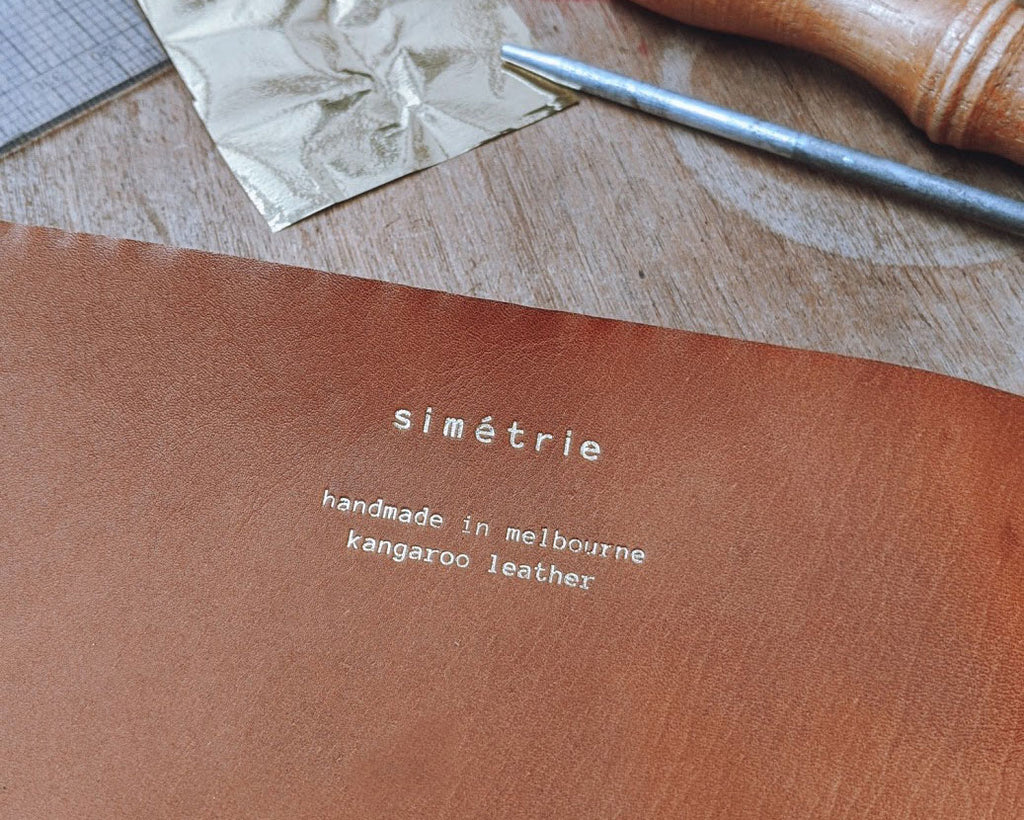 simétrie logo & handmade in melbourne text on kangaroo leather