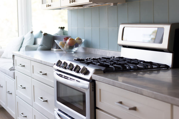 range top stove cabinetry hardware tile backsplash
