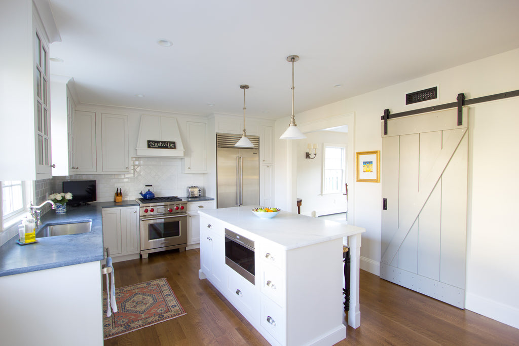 kitchen overview white cabinetry barn door