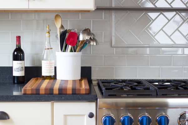 range top stove kitchen utensils tile backsplash 