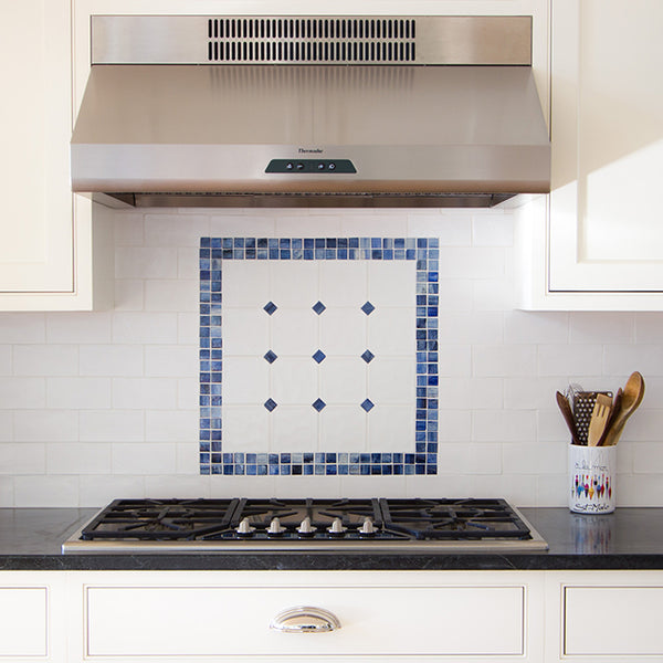 tile backsplash blue pattern above gas stove