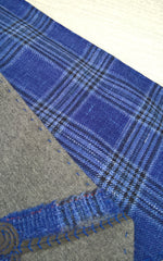 Grey wool and bright blue check fabric being made into a cravat