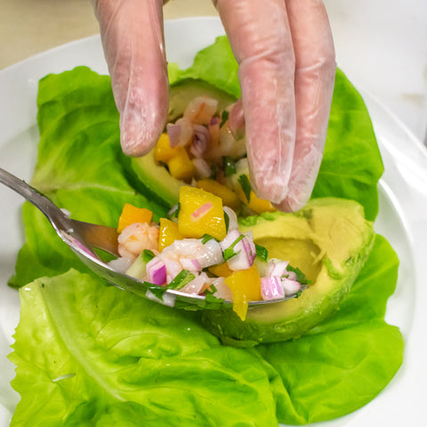 serve ceviche in avocado halves over a bed of lettuce