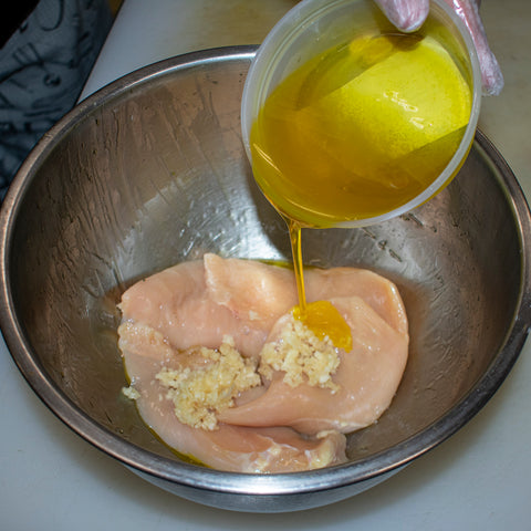 add olive oil to chicken and garlic