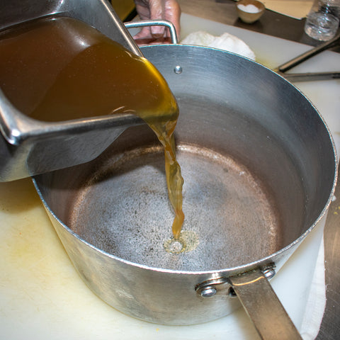 Pour beef bone broth into saucepan and simmer