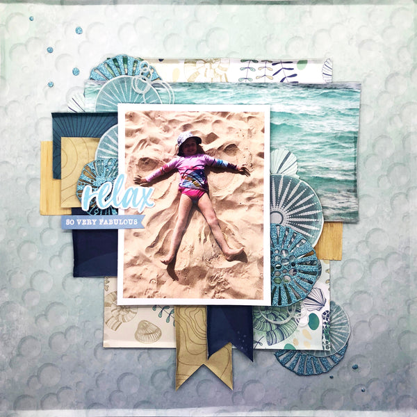 travel scrapbooking layout with a girl laying on the beach 