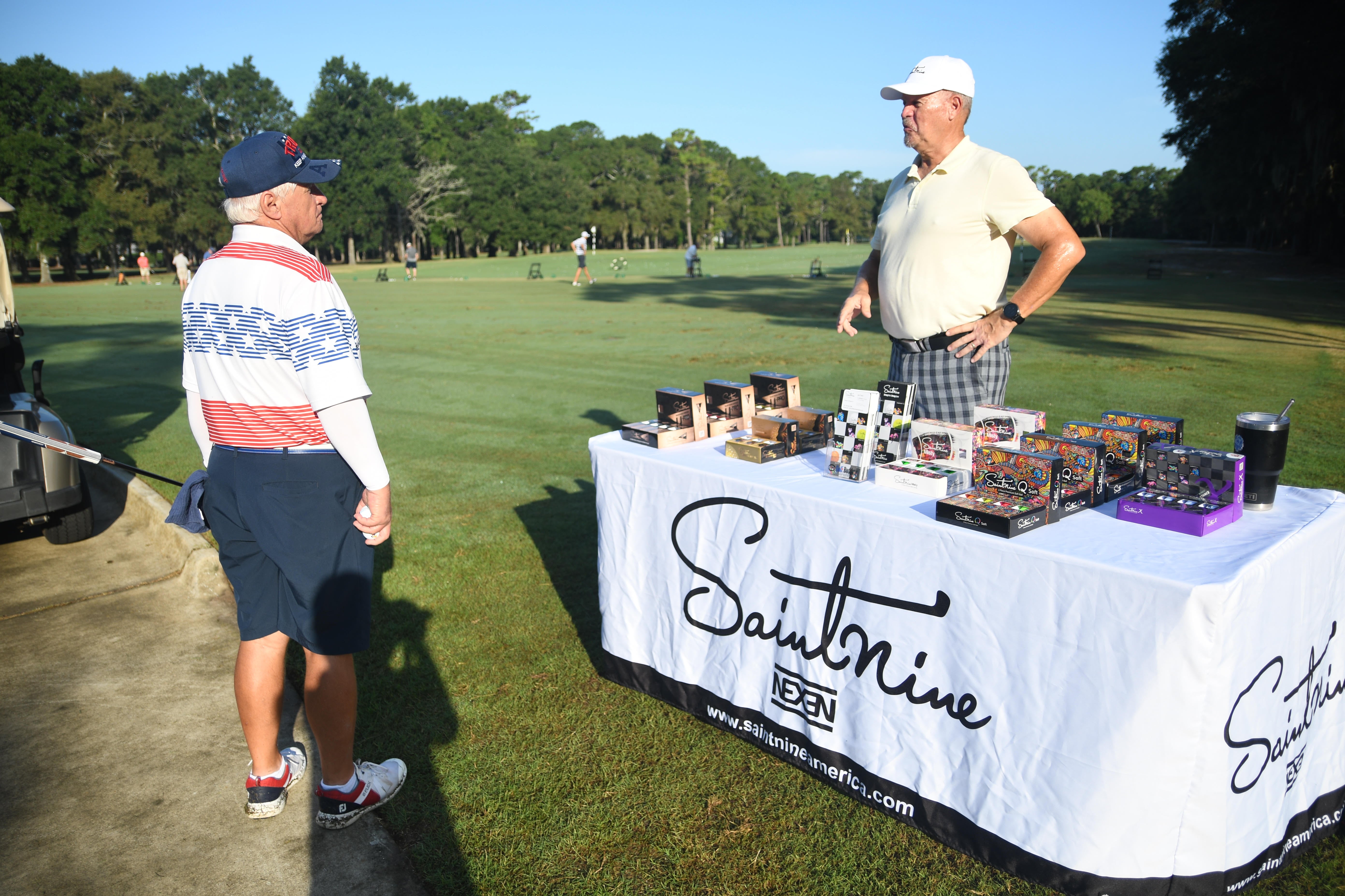 Image of the Saintnine Booth at the Saintnine Shootout golf event. 