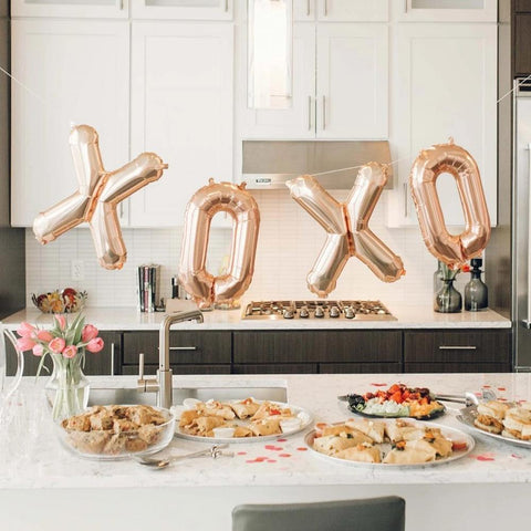 White kitchen with XOXO balloons hanging above counter