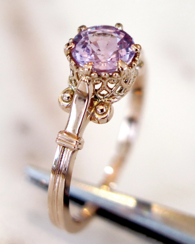 Pietra sapphire ring held with tongs